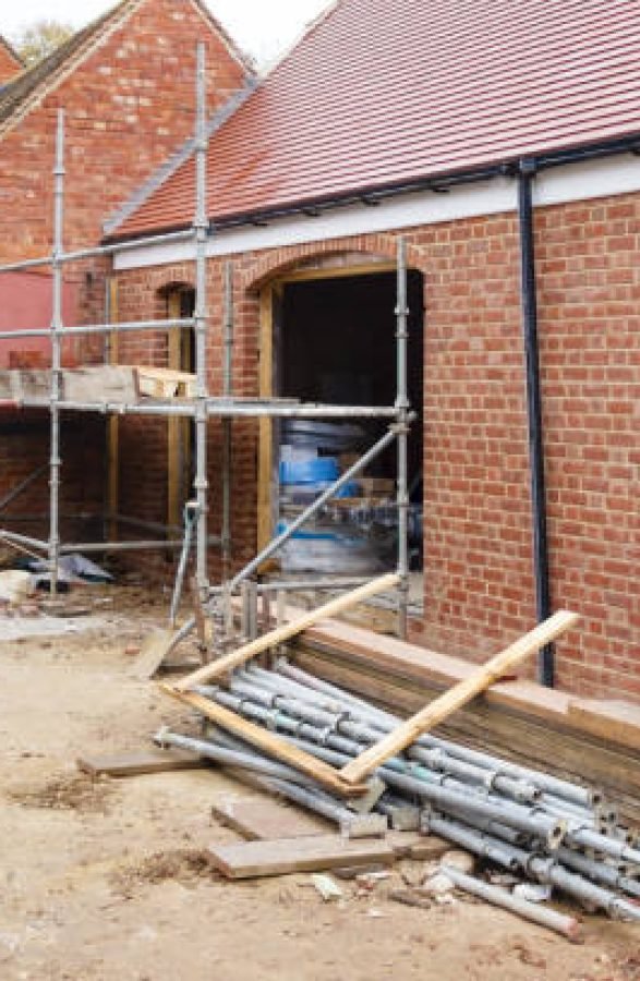 Building site in UK with brick house extension under construction